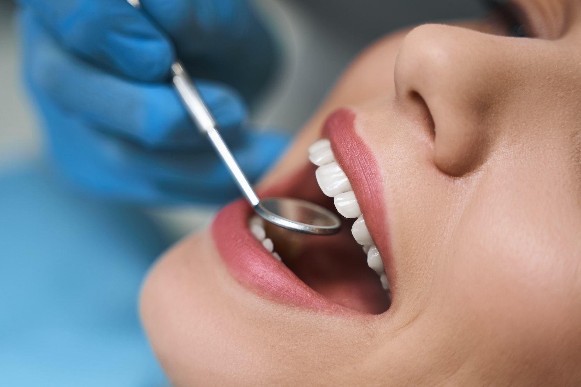 Dentist is examining young woman stock photo